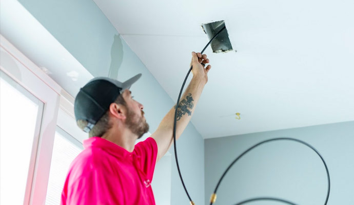 Person sanitizing HVAC air ducts